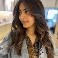 Another view of this beautiful warm-toned balayage. The face-framing layers and soft waves create a stunning, effortless style.