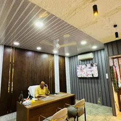 This is my office, designed with our own products. The combination of dark wood, textured white panels, and a modern PVC ceiling creates a professional and stylish environment.