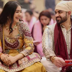 Candid moments are the best. For our Mata Ki Chowki, his simple striped kurta with a rich velvet shawl perfectly balanced the heavy embroidery of my yellow Anarkali, creating a beautiful contrast.