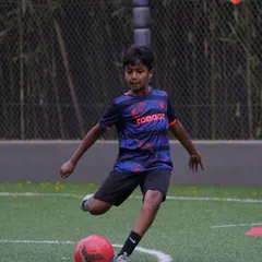 A young player executes a perfect shot during a personal training session, a direct result of the focused guidance from his coach.