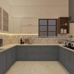 This U-shaped kitchen features a classic duco finish in a sophisticated grey-blue. The design includes wall units with traditional glass shutters, an open spice rack for easy access, and a breakfast counter opposite the cooking zone.