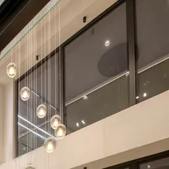 A detail of the cascading pendant lights in the triple-height volume of the Kedia's Residence. I select lighting that acts as jewelry for the space, enhancing the architecture.