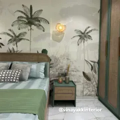 Bringing the outdoors in with this nature-inspired bedroom. The tropical wallpaper, rattan headboard, and sage green accents create a calm and refreshing atmosphere. The custom wardrobe and bedside table complete the cohesive, earthy look.