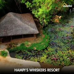 A tranquil cottage at Hampi's Whiskers Resort, situated by a serene lily pond. This stay offers a peaceful retreat, allowing you to relax in nature after exploring the magnificent ruins of the Vijayanagara Empire.
