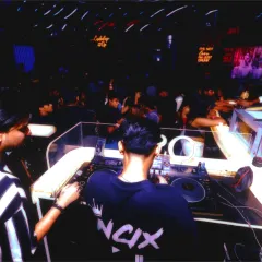 A view from behind the console, showing a packed dance floor. My focus is always on reading the room and playing the right tracks to keep the party going.