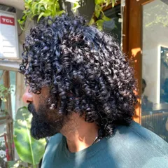 The side profile showcases the volume and shape of the haircut. This style is both modern and timeless.