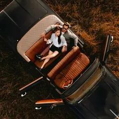 An aerial shot from a pre-wedding film in Lonavala, featuring a classic vintage car. This kind of drone videography adds a grand, cinematic feel to your love story, turning a simple drive into an unforgettable scene.
