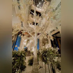 The centerpiece of a winter wonderland theme: a magnificent, life-sized white tree. This stunning installation creates a focal point and sets a magical, frosty tone for the entire event space.