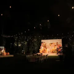 A wide view of the magical evening we created for Yatharv Yash's 4th birthday. The entire outdoor space at the Taj West End was transformed with warm string lighting, a custom "Y" initial backdrop, and fun activity stations for the children. Note: Media 15 is a duplicate of this image.