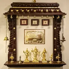 We also create timeless, traditional pooja units. This wall-mounted mandir is crafted from dark, polished wood with intricate carvings along the top, reminiscent of South Indian temple architecture. It features classic brass bells and provides a beautiful, space-saving solution for honoring tradition in any home.