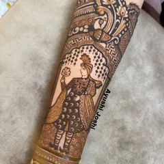 The finished portrait of a groom (dulha) holding a lotus, framed by majestic peacocks. I teach the specific shading and line work techniques needed to create clear and expressive human figures in your mehendi.