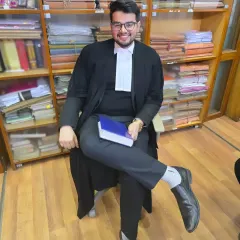In my chamber, surrounded by law books. I believe fearlessness is the most essential quality for an advocate, allowing me to represent my client's case with courage and conviction before the court.
