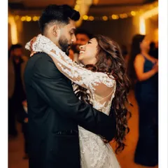 A happy, candid moment during the first dance. I focus on capturing the genuine smiles and connection between the couple as they celebrate.