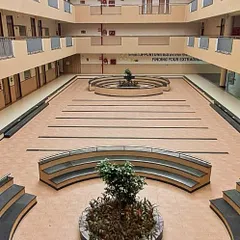 The central atrium of the EuroSchool campus, designed as a multi-functional common area. This expansive, naturally lit space encourages student interaction and hosts school events, featuring tiered seating and open corridors across multiple floors.