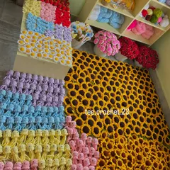 A massive wholesale order laid out, featuring a huge number of sunflowers and colorful rows of amigurumi jellyfish.