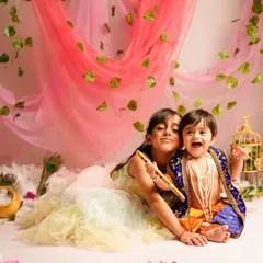 A beautiful moment between siblings dressed as Radha and Krishna. Including older siblings in themed photoshoots creates precious memories of their special bond.