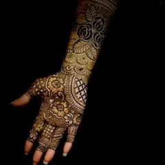 A close-up of the intricate floral and jaali patterns from the same design, showcasing the deep, consistent color achieved with my natural henna.