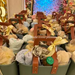 A closer look inside our popular olive green tote bag hamper. This one includes a soft hand towel, a cute teddy bear, a jar of gourmet honey, and other small treats, all beautifully arranged.