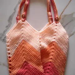 I designed this Chevron Tulip Bag to be the perfect carry-all for my crochet projects. The sturdy chevron stitch gives it a lovely shape and texture, and it’s spacious enough to hold plenty of yarn and tools for crafting on the go.