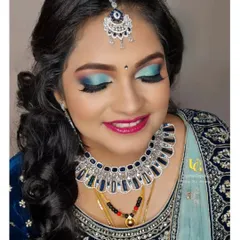 A close-up of Akshatha's stunning reception makeup. She wanted a glamorous look with glitter, and I loved creating this bold blue smokey eye to match her velvet lehenga.