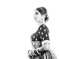 A high-contrast black and white portrait that feels like a piece of art. This style emphasizes the bride's features and the intricate details of her attire.