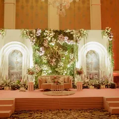 I love bringing the romance of a garden indoors. This stage for a ring ceremony was designed with a lush wall of cascading florals and greenery, framed by softly lit arches to create an enchanting, fairytale setting for the couple's special moment.