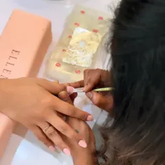 The process starts with meticulous prep work. Here, I am carefully tending to the cuticles to create a clean and healthy base before applying any polish or extensions.