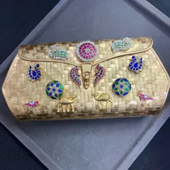 Another look at the stunning gold-plated fusion clutch. The basket-weave texture of the silver base provides a beautiful backdrop for the vibrant, hand-placed motifs.