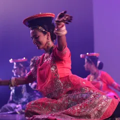 A dynamic shot from a stage show, performing a folk dance with pots. We can incorporate unique props and themes to make your sangeet performance stand out.