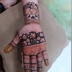 A single-hand view of a lovely guest mehndi design. The pattern includes lotuses, a dotted grid, and a floral wristband, offering a full look that can be applied quickly.