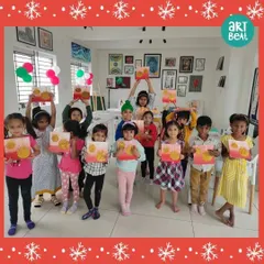 A group of young artists from our Christmas art party, holding up the beautiful paintings they created. We love seeing their unique interpretations of the theme.