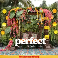 For pre-wedding functions like Mehendi or Haldi, I love creating vibrant, joyful spaces. This traditional wooden jhoola, heavily decorated with marigolds and bougainvillea against a lush green wall, is a perfect photo spot.