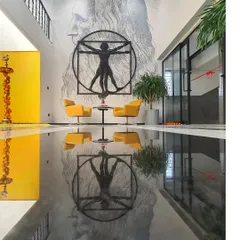 A wall dedicated to the maestro, Leonardo da Vinci. This installation combines a painted self-portrait with a metal sculpture of the Vitruvian man, creating a powerful homage to one of history's greatest creative minds.