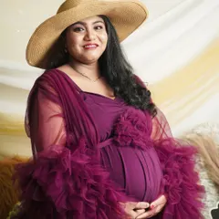 This portrait showcases a stylish boho look with a rich plum gown and a wide-brimmed hat. We bring all the elements, including the backdrop and props, to create this vibe at your home.