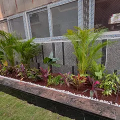 Here is another angle of the Lodha Villa garden bed. The design provides a beautiful view from the windows and adds significant curb appeal to the property, transforming a plain exterior wall into a lush, tropical-style garden.