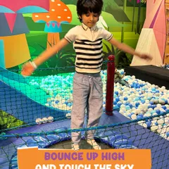 Bounce up high and touch the sky! A young boy enjoys our trampoline zone, a favorite spot for kids to burn off energy and experience the simple joy of jumping.