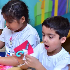 This is the moment of discovery I love to see. In my creative workshops, kids get to explore their curiosity and learn by doing, like this young camper completely absorbed in an arts and crafts project.