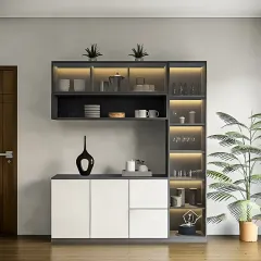 A modern, floating crockery unit in a grey and white finish. The asymmetrical design includes glass-fronted cabinets with lighting to display items, as well as concealed storage.