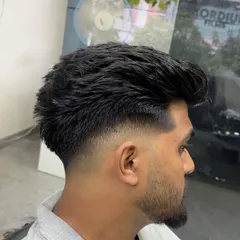 A side profile of a textured haircut with a mid-fade. This is a versatile look that can be styled in many different ways.