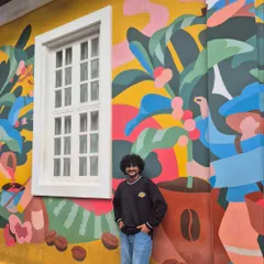 Posing against a vibrant mural in the streets of Pondicherry. Our city getaways are full of these colorful discoveries.