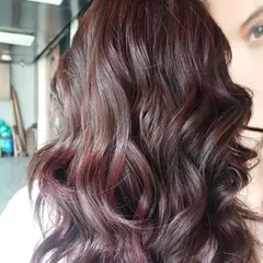 A gorgeous example of color blending with rich red and mahogany tones. This look was created without bleach, using a combination of balayage and babylights to weave different shades together for a seamless, dimensional result.
