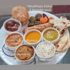 I believe in offering a full, satisfying meal. This plate shows a typical wedding menu I can create, with everything from Paneer Tikka Masala and Veg Kolhapuri to Aamras, Gulabjamun, and fresh Naan.