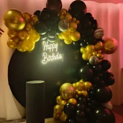For a sleek and modern celebration, I designed this black and gold themed birthday setup. It features a dramatic balloon garland, a circular black backdrop, and a "Happy Birthday" neon sign for a chic, high-contrast look.
