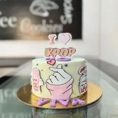 An "I Love K-Pop" cake for a music fan. The design includes the iconic finger heart gesture and other fun elements related to the K-Pop world.