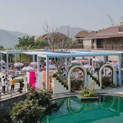 A dreamy pastel setup by the poolside for a Haldi ceremony. The soft hues of the decor, combined with the tranquil water and mountain view, created a serene and aesthetically pleasing haven.