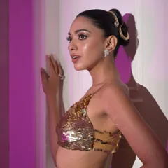 This angle shows how the sleek bun and accessory work with the model's profile. It's a testament to creating 360-degree hairstyles for photoshoots.
