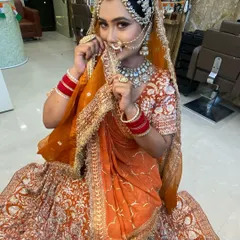 I love creating traditional looks, and this Marwadi bride was a joy to work with. Her look features a stunning orange lehenga and an elaborate borla and matha patti, which are key elements of Marwadi bridal attire.