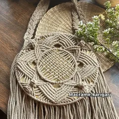 The same round macramé beach bag design in a classic beige. This neutral color is versatile and showcases the detailed knot work and texture of the natural cotton cord.