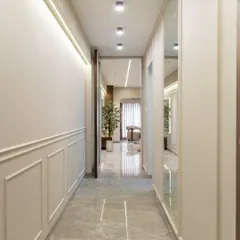 A passage that speaks quiet elegance. Classic wall mouldings, subtle mirrors, and a calming neutral palette come together to create depth, dimension, and timeless charm in this transition space.