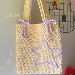 A closer look at the texture and details of my star and bow crochet tote bag. The plush yarn makes it super soft to the touch while being sturdy enough for everyday use.